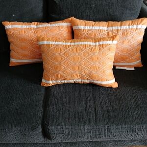 Set of Three Orange Quilted Throw Pillows